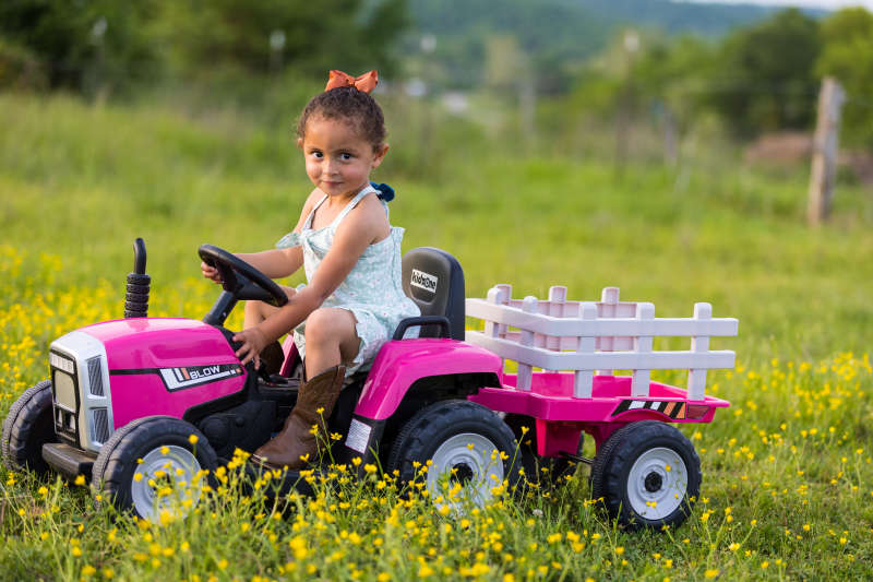 Cute kid on toy tractor